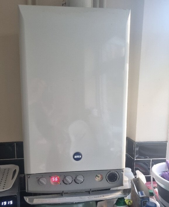 A Baxi combi boiler in a childminder’s home being inspected as part of a Legionella risk assessment
