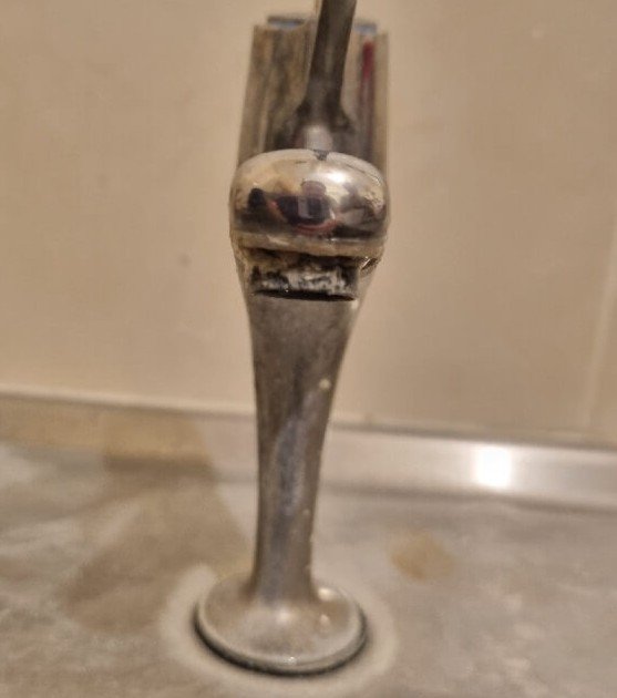 Inspection of a nursery tap for limescale and biofilm during a Legionella risk assessment.