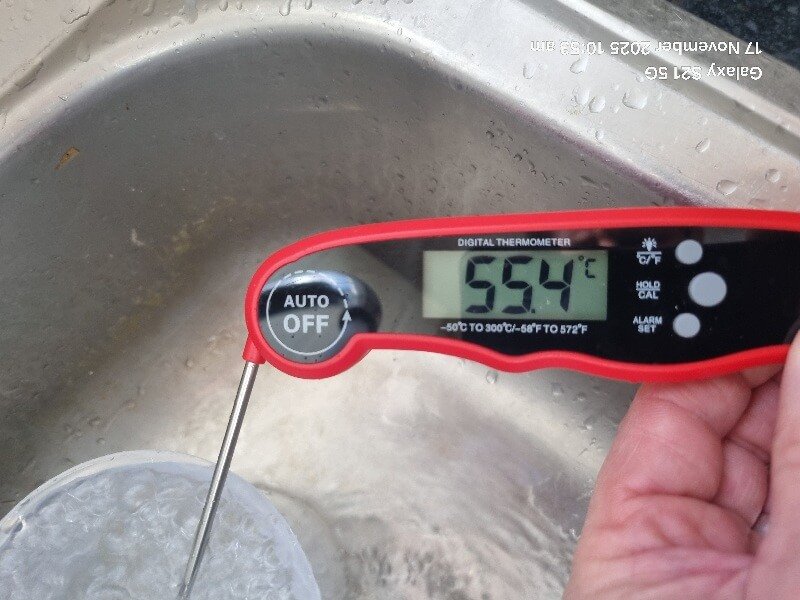 Hot water temperature being tested with digital probe during Legionella testing in Doncaster.