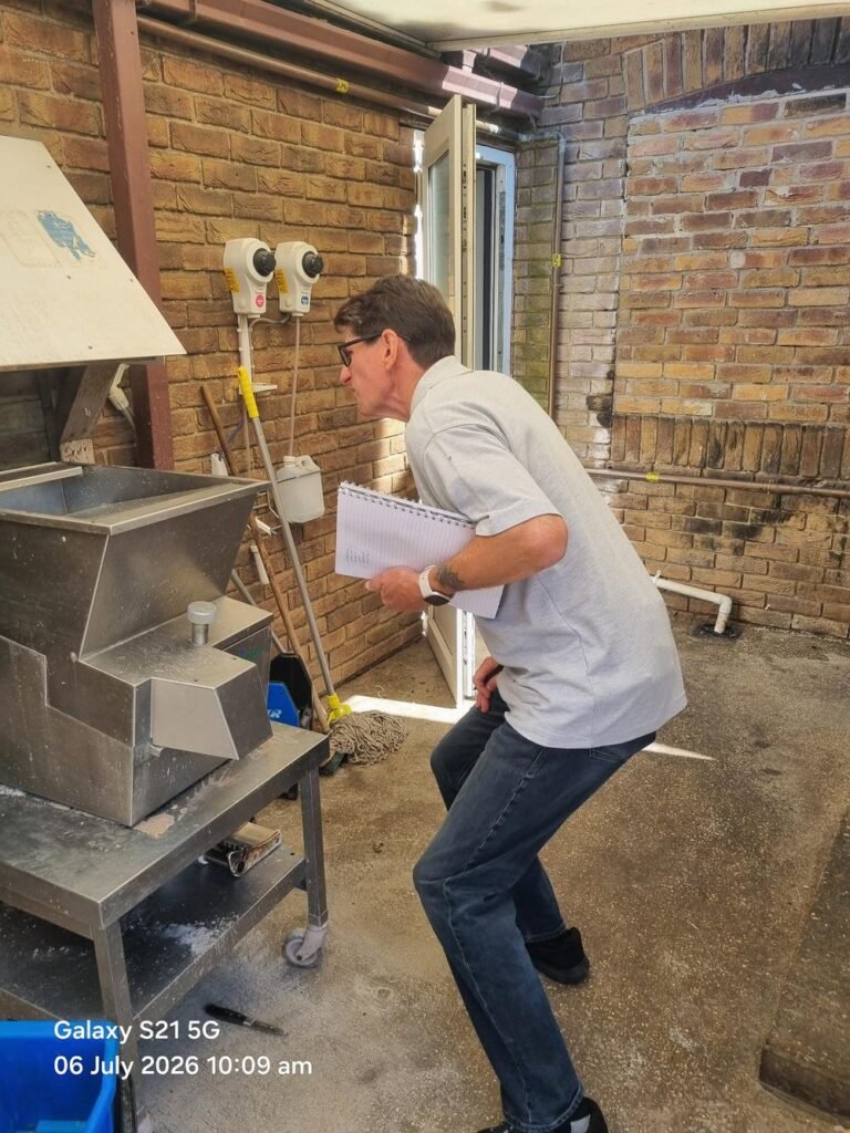 Legionella risk assessor inspecting commercial catering equipment during a water system assessment