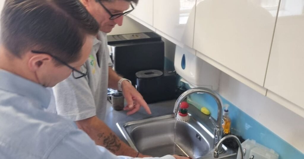 Little-used tap being checked as part of Legionella control in a building
